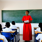 Modern Classroom in Comoros**

"A bright and modern classroom in Comoros, fully clothed students attentively listening to a female teacher in professional dress, interactive whiteboard displaying educational content, safe for work, appropriate content, modest setting, perfect anatomy, correct proportions, natural pose, high-resolution image, well-lit, family-friendly."

**